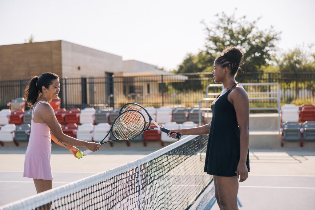 two female tennis players playing at great park tennis courts