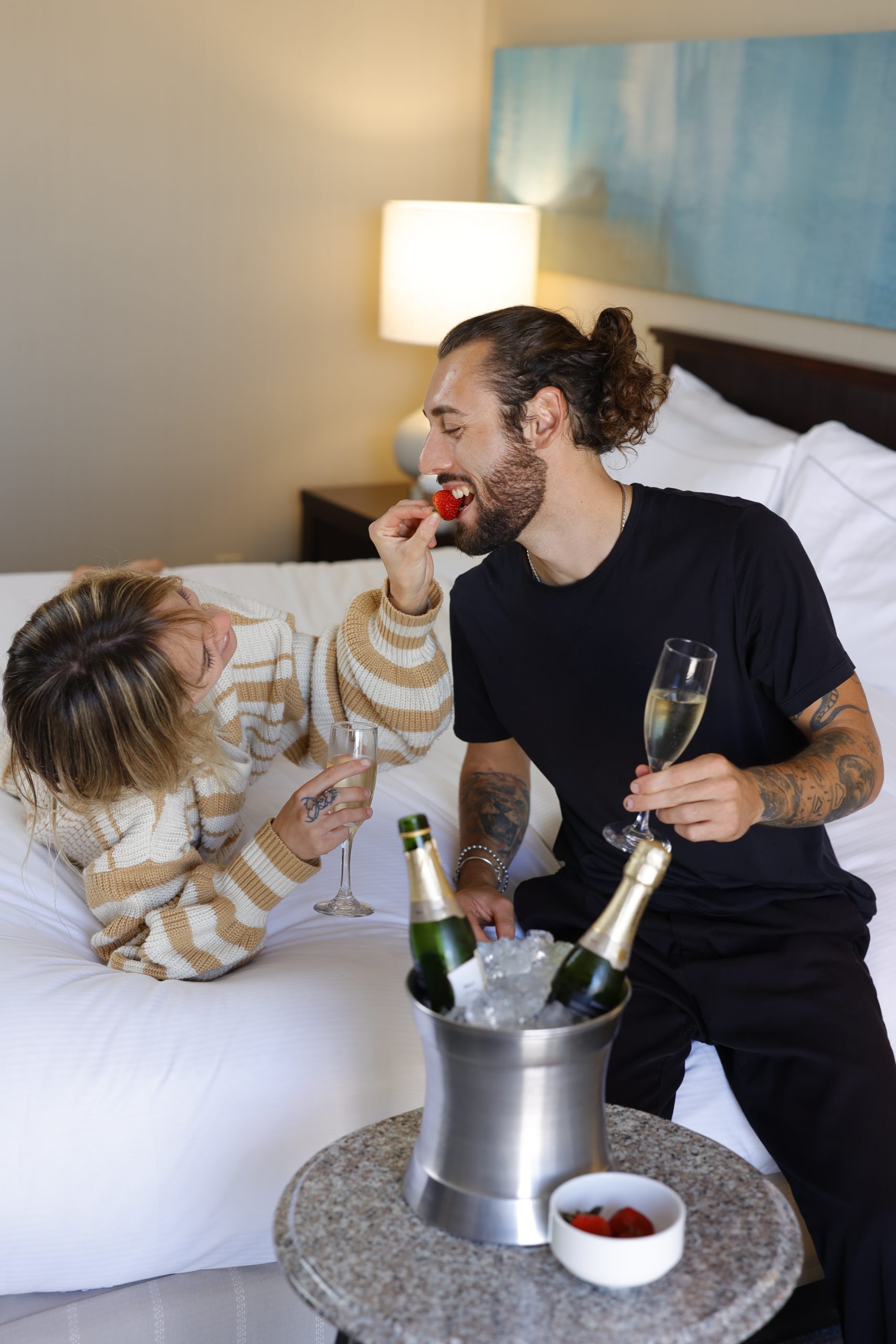 couple enjoying strawberries at room at hilton irvine