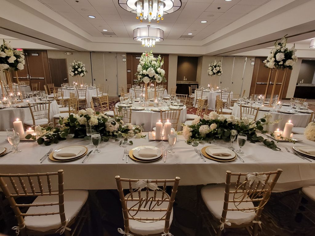 wedding reception set up inside ballroom with flowers and china at doubletree spectrum