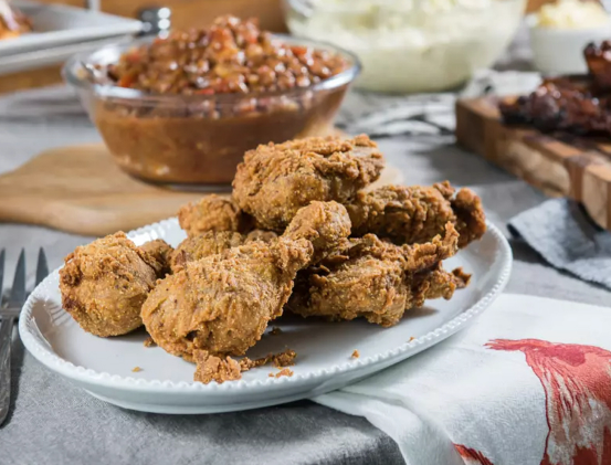 plate of fried chicken, bowl of beans and rice from georgia's restaurant