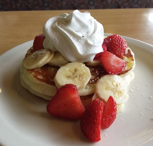 pancake with whipped cream, banana and strawberry