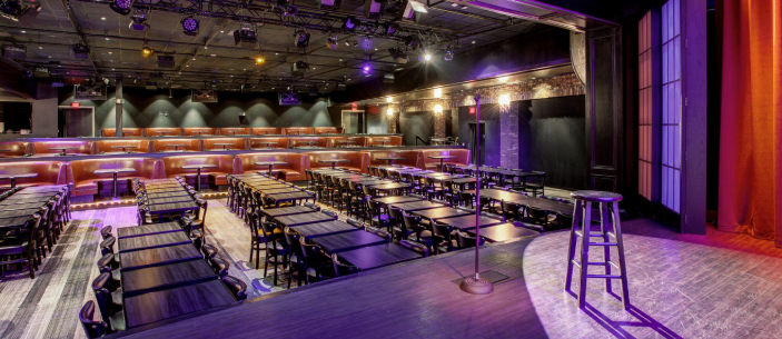 dining area and stage with mic at irvine improv