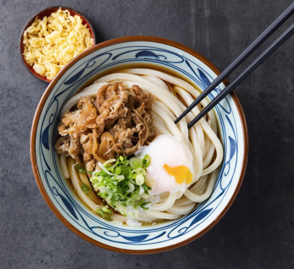 a bowl of noodles with beef at marugame udon