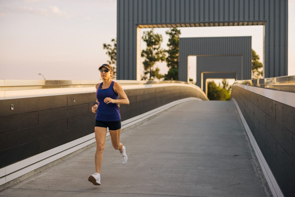 woman running on a bridge